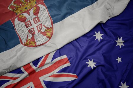 waving colorful flag of australia and national flag of serbia. macroの写真素材