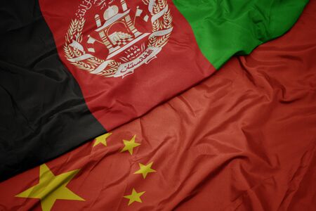 waving colorful flag of china and national flag of afghanistan. macroの写真素材