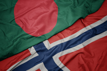 waving colorful flag of norway and national flag of bangladesh. macroの写真素材