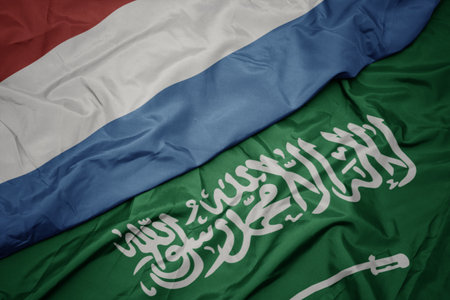 waving colorful flag of saudi arabia and national flag of luxembourg. macroの写真素材