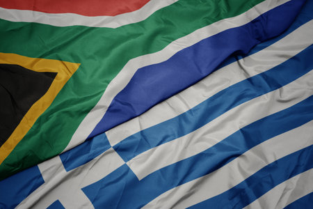 waving colorful flag of greece and national flag of south africa. macroの写真素材