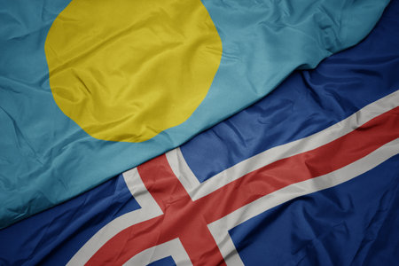waving colorful flag of iceland and national flag of Palau . macroの写真素材