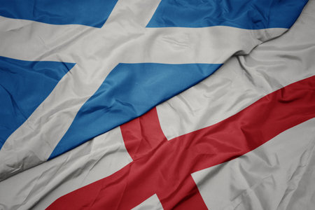 waving colorful flag of england and national flag of scotland. macroの写真素材