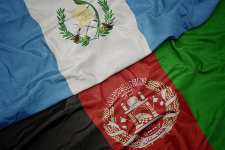 waving colorful flag of afghanistan and national flag of guatemala.の写真素材