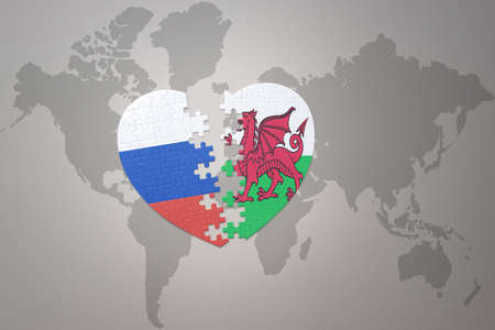 puzzle heart with the national flag of russia and wales on a world map background. Concept. 3D illustrationの写真素材