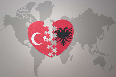 puzzle heart with the national flag of turkey and albania on a world map background. Concept. 3D...