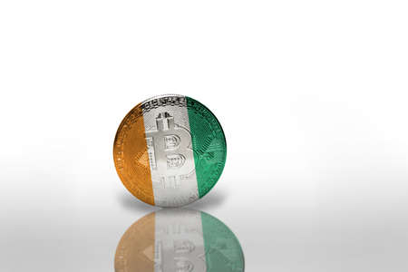 bitcoin with the national flag of cote divoire on the white background. bitcoin mining concept. 3d illustrationの写真素材