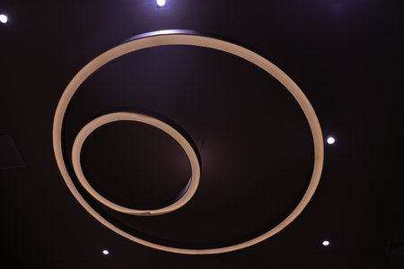 A large circular lamp illuminates a public park.