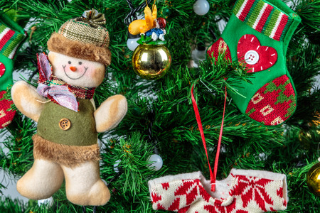 Christmas ornaments on tree with snowman and sock.の写真素材