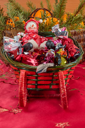 Snowman and a candy sledge as Christmas ornamentの写真素材