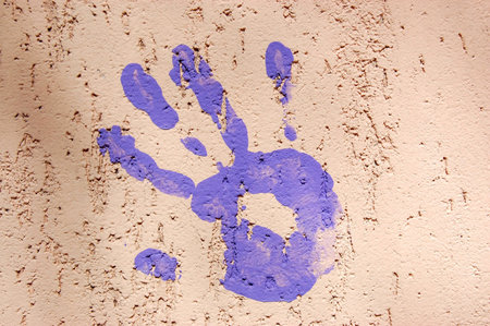 Blue hand print on pink wallの写真素材