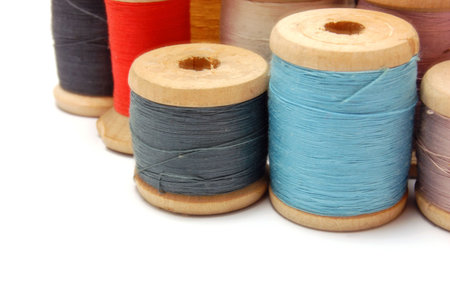Old Thread reels of different colors isolated on white background