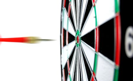 Dartboard with flight of dart on the bullseyeの写真素材