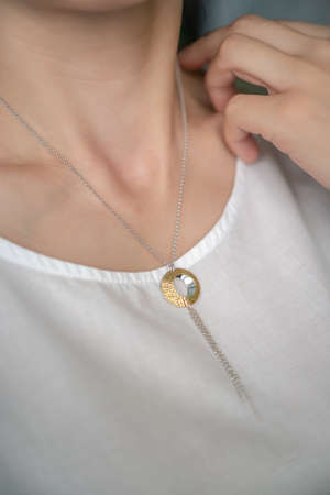 necklace on womans neck on dark backgroundの写真素材