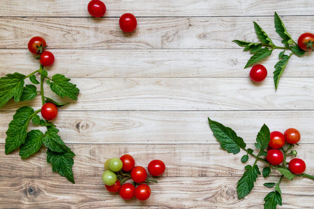 cherry tomatoes on wooden table background dark light leaves