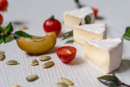 Charcuterie vegetarian board of assorted cheeses, vegetables and appetizers. Top view table scene on...