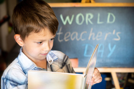 World Teacher's Day, pupil boy near the chalkboard, chalk text