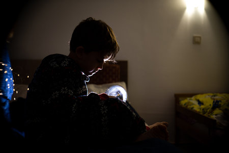 Christmas boy dreams of evening childhood tree holiday flashlights