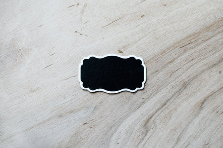 Black label on the Real Natural white wooden wall texture background. The World's Leading Wood soft...