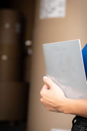 Girl reading blank black flyer brochure booklet. Leaflet presentation. Pamphlet hold hands. Woman show clear offset paper. Sheet template Booklet design sheet display read first person.の写真素材