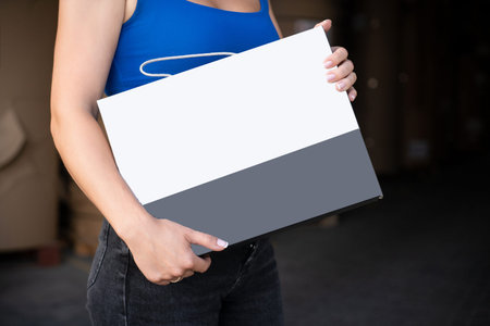 Girl reading blank black flyer brochure booklet. Leaflet presentation. Pamphlet hold hands. Woman...