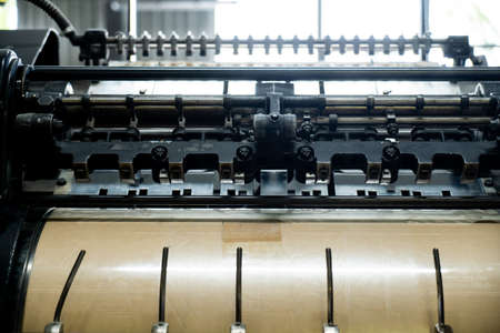 Offset printing machine feeder transfer metallic paper through the feeding table to the printing unit factoryの写真素材