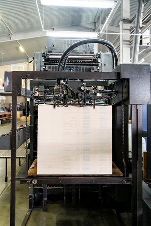 Offset printing machine feeder transfer metallic paper through the feeding table to the printing unit factoryの写真素材