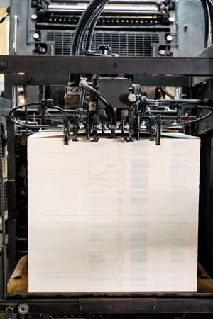 Offset printing machine feeder transfer metallic paper through the feeding table to the printing unit factoryの写真素材