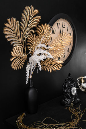 Interior design vases with flowers and candles clock and old retro vintage phone on the fireplace...