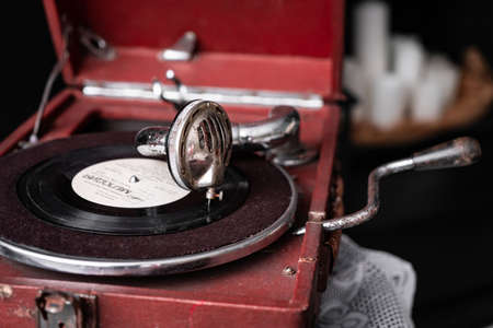 Head with a retro old vintage style gramophone needle on the vinyl disc closeupの写真素材