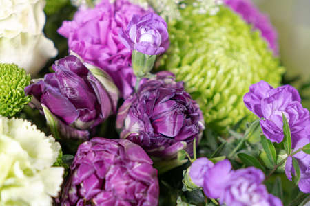 Bouquet of pink roses, alstroemeria flowers orchids. Fresh summer flowers against gray backgroundの写真素材