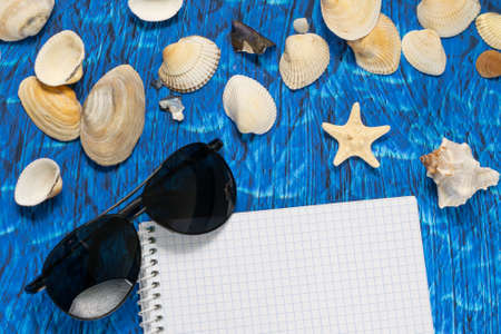 flat lay blue background blank notebook copy space. summer plans conceptの写真素材