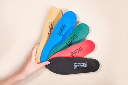 Orthopedic insoles for shoes on a color backgroundの写真素材