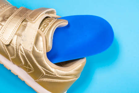 Orthopedic insoles for sports shoes. Treatment and prevention of flatfeet and orthopedic foot diseases. Foot care, feet comfort. Health care wearing comfortable shoesの写真素材