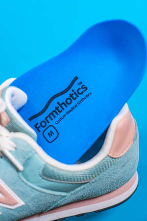 Orthopedic insoles for shoes on a color backgroundの写真素材