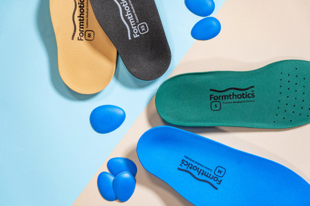 Orthopedic insoles for shoes on a color backgroundの写真素材