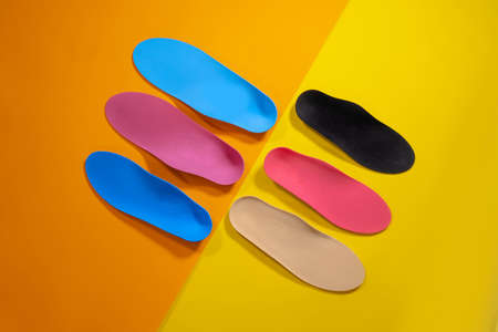 Orthopedic insoles for shoes on a color backgroundの写真素材