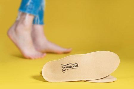 Orthopedic insoles for shoes on a color backgroundの写真素材