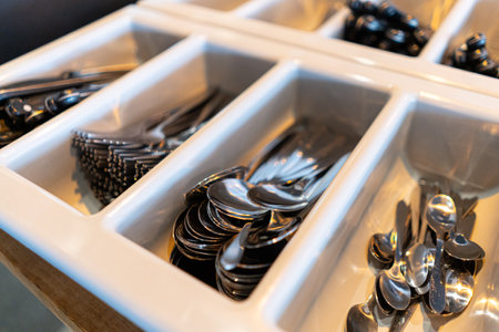 Clean spoons, forks and knives in the kitchen in a cafe. Cutlery in a restaurant.の写真素材