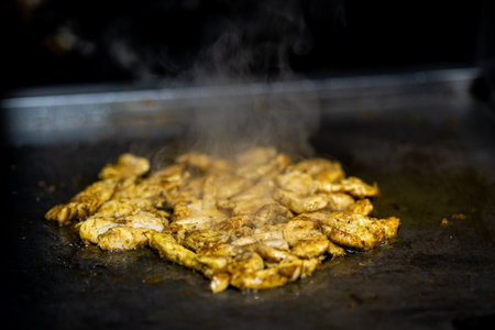 Close up photograph of chicken pieces on the barbecueの写真素材