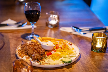 healthy barbecue. Chicken kebab with vegetables and herbs, salad and red wine candlesの写真素材