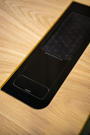 Mobile phone with wireless charger table. Modern workplace accessory