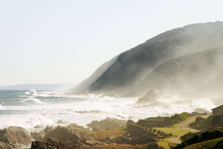 ocean-scape with foaming waves and mountainsの写真素材