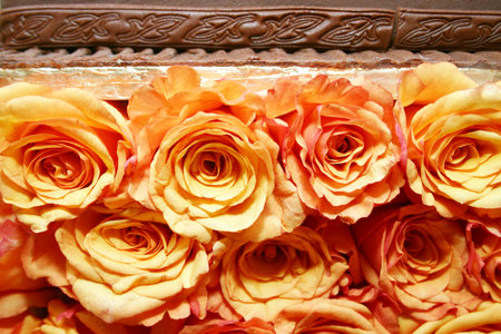 chocolate cake decorated with orange fresh rosesの写真素材
