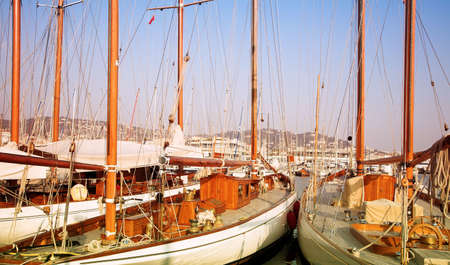Expensive wooden yachts tied up in Mediterranean sea harborの写真素材