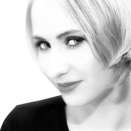 Woman with short hair and strong eye-contact in black and white - head and shoulders portraitの写真素材