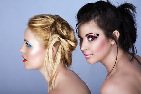 Two beautiful young women with fashion make-up and modern hairstyle Ð not isolatedの写真素材