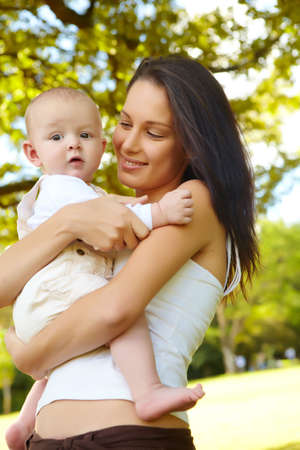 young woman with her baby son in the parkの写真素材