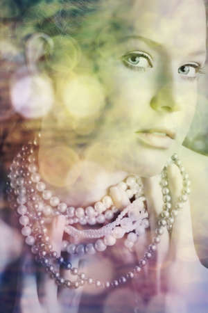 beautiful woman with blue eyes in pearl necklace with bokeh lights - nearest eye in perfect focus.の写真素材