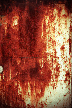 grunge metal door with rusted peeling paint in deep red and blue colourの写真素材